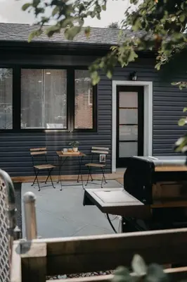 a patio with chairs and a table in front of a house at The Hideout in Barrie
