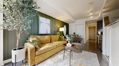 a living room with a couch and a table at Cozy 1BR Condo in Core Toronto in Toronto