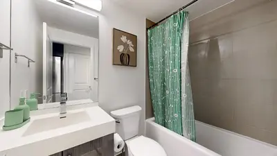 a bathroom with a sink and a toilet and a shower at Cozy 1BR Condo in Core Toronto in Toronto