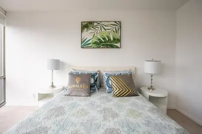 a bedroom with a bed with pillows and two lamps at 1BR High Floor View Downtown Toronto in Toronto
