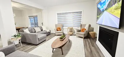 a living room with a couch and a fireplace at Muskoka Luxury Getaway in Gravenhurst