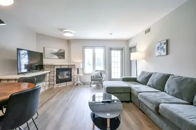 a living room with a couch and a table at Perfect Jacuzzi Suite at Highland in Shanty Bay