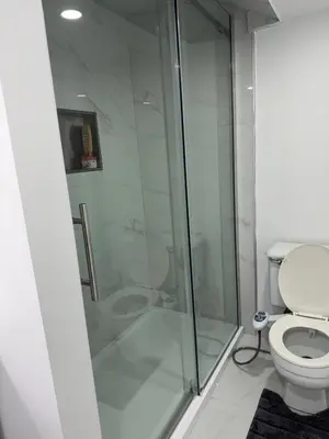 a bathroom with a shower and a toilet at Studio Basement Apartment in Kitchener
