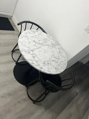 a table and a chair with a table at Studio Basement Apartment in Kitchener