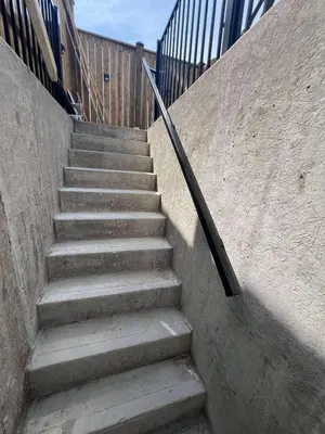 a set of concrete stairs with a railing at Studio Basement Apartment in Kitchener
