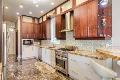 a kitchen with wooden cabinets and a stove top oven at Private Oasis in King City in King City