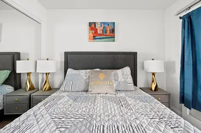 a bedroom with a large bed with two lamps at Attractive 1 Bedroom High Floor with Skyline View in Toronto