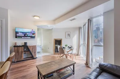 a living room with a couch and a table at Modern Down Town Condo Near CN Tower with Fast WiFi in Toronto