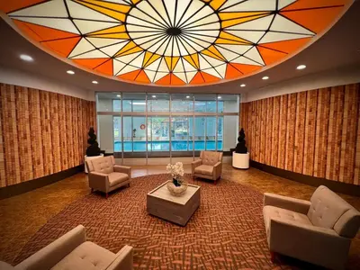 a large lobby with a large stained glass ceiling at Lower Penthouse Suite with Pools & Sunset Views in Toronto