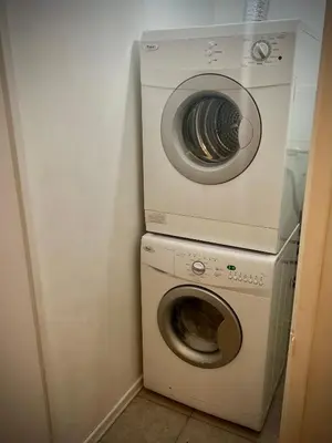 a washing machine and a washer in a room at Lower Penthouse Suite with Pools & Sunset Views in Toronto