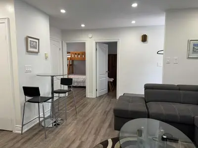 a living room with a couch and a table and a bed at Comfortable waterfront vacation Keswick in Georgina