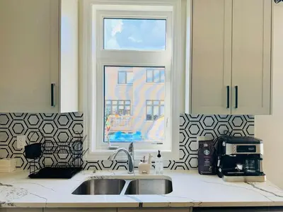 a kitchen with a sink and a window at Beautiful Brand New House in Keswick 8 guests in Georgina