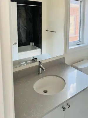 a bathroom with a sink and a mirror at Beautiful Brand New House in Keswick 8 guests in Georgina