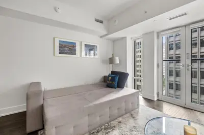 a living room with a couch and a glass table at Modern 1Bd & Den in Downtown Toronto in Toronto