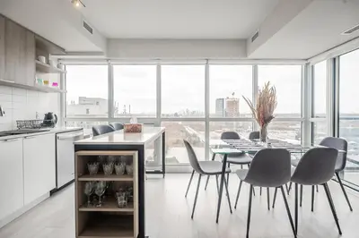 a kitchen and dining room with a table and chairs at Panoramic view Condo 2 BR 2 BA Free parking in Toronto