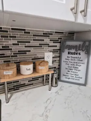 a store with baskets on a bench in front of a brick wall at Equipped Basement Great Location in London