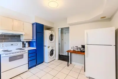 a kitchen with white appliances and blue cabinets at Family-Friendly 2BR - Sleeps 6 in Hamilton