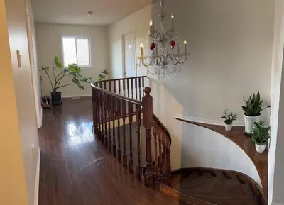 a staircase in a living room with a chandelier at Bright private single bedroom V02 on second floor in Mississauga