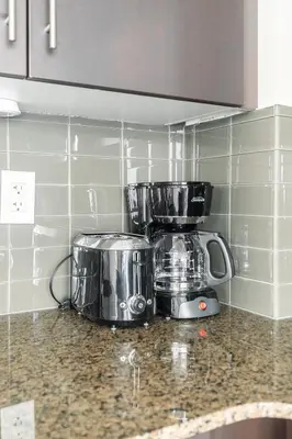 a kitchen counter with a toaster and a blender at Classic 1BR & Den Apartment in Downtown Gym Pool in Toronto