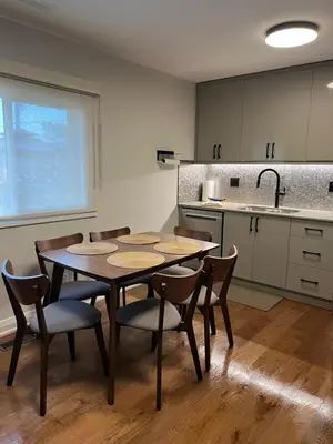 a kitchen with a table and chairs in a room at Adrian's Suites 2 Bedroom FamilySuite in Wasaga Beach