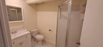 a bathroom with a shower and a toilet and a sink at Century House on Quarter acre lot in Acton