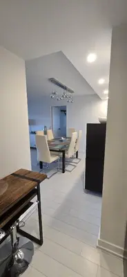 a dining room with a table and white chairs at Spectacular Large 3 Bedroom 3 Bath Condo Downtown Toronto Lakeview in Toronto