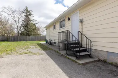 a house with a staircase on the side of it at Stewarts Place Newly Renovated Basement City Apartment in Hamilton