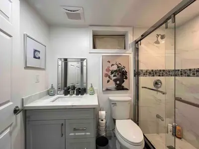 a bathroom with a toilet and a sink and a shower at Elegant Oakville Town Residece in Oakville