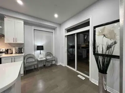 a kitchen with a vase with flowers in it at Elegant Oakville Town Residece in Oakville