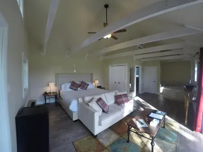 a living room with a white bed and a couch at Eganridge Resort, Golf Club & Spa in Bobcaygeon