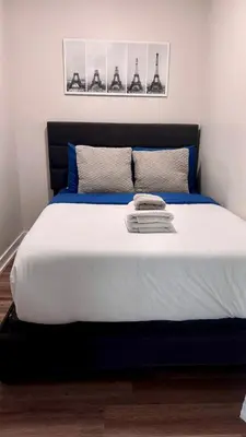 a bedroom with a large bed with blue and white sheets at Downtown Toronto luxury condos in Toronto