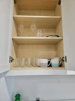 a cupboard with glasses and cups on it at Downtown Toronto luxury condos in Toronto