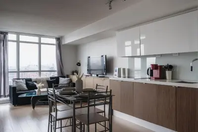 a kitchen and living room with a couch and a table at Downtown Toronto luxury condos in Toronto