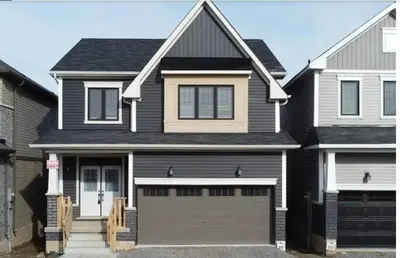 a black house with a garage at New 3 Bedroom 2 Bathroom Home in West Niagara in Thorold