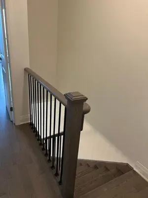 a wooden staircase in a hallway with a wooden floor at Bowmanville Room in Bowmanville