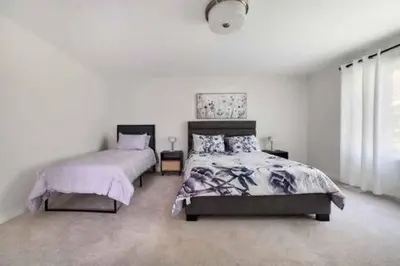 a bedroom with two beds and a window at Severn Woodland in Severn