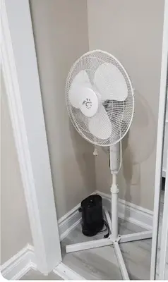a white fan sitting in the corner of a room at 3 bdrm 3 bath bsmt Brampton Toronto, Sleeps 16 in Brampton