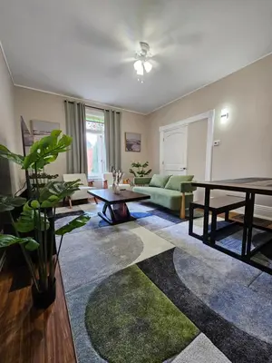 a living room with a couch and a table at King Comfort Retreat in Peterborough