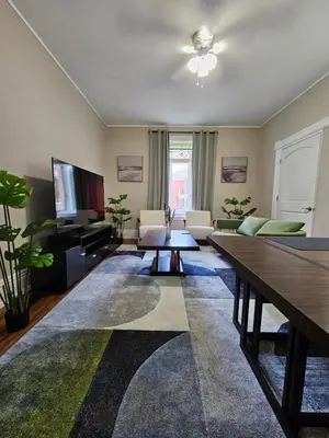 a living room with a couch and a table at King Comfort Retreat in Peterborough