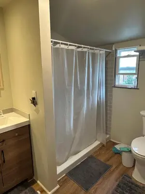 a bathroom with a shower with a white shower curtain at Tom home in Toronto