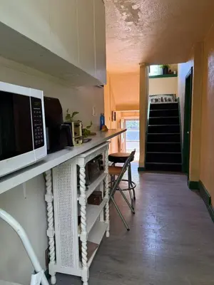 a kitchen with a counter top with a microwave at Tom home in Toronto