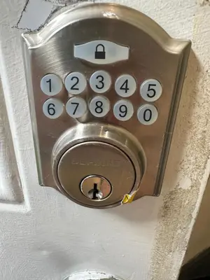 a close up of a door lock with a number pad at Toronto Upper Beaches Apartment in Toronto
