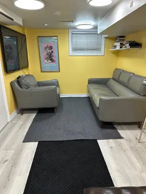 a living room with two couches and a yellow wall at Toronto Upper Beaches Apartment in Toronto