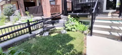 a bench on the side of a house at The Cozy Bungalow in North York Nest in Toronto