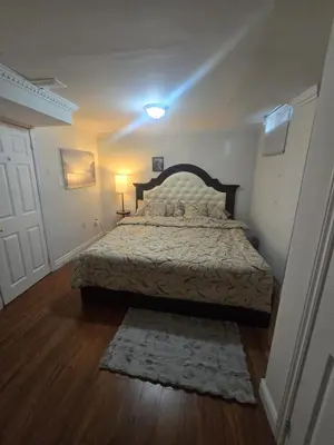 a bedroom with a bed in a room with a door at Private in Mississauga