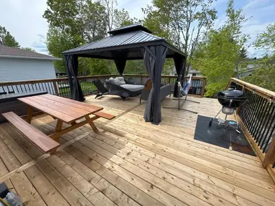 a wooden deck with a gazebo and a grill at Hot Tub BANYA Sauna True Cottage experience in Innisfil