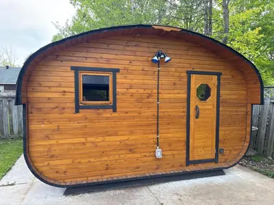 a large wooden shed with a door and a window at Hot Tub BANYA Sauna True Cottage experience in Innisfil