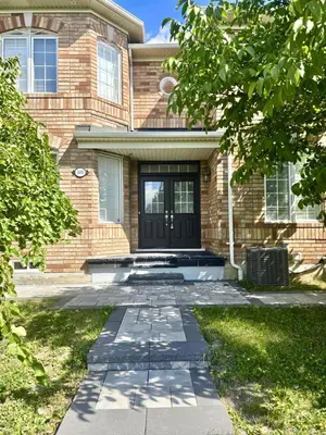 a brick house with a black front door at Quincy Home in Mississauga
