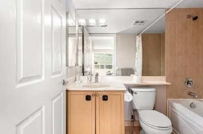 a bathroom with a toilet and a sink and a tub at SkyView 2BR Plus Den Stunning Views Steps to SQ1 Mall in Mississauga