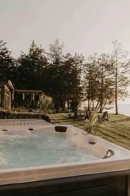 a jacuzzi tub with a view of the water at Waterfront Casa in wine County with SAUNA and HOT TUB in Demorestville